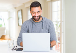 Man sitting at laptop happy.